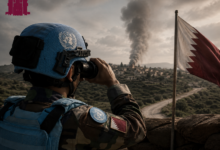 UN peacekeeper observing conflict-affected area in Lebanon as smoke rises in the distance with Qatar flag visible