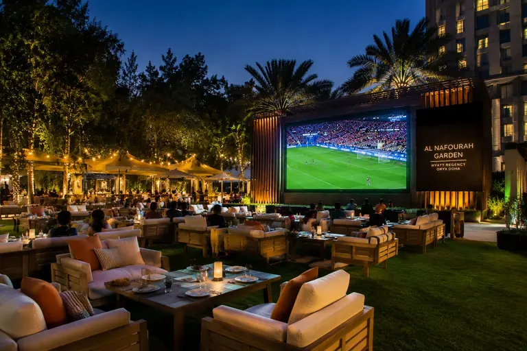 Al Nafourah Garden at Hyatt Regency Oryx Doha hosting an outdoor football match screening