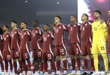 Qatar national football team players standing together before a FIFA World Cup match