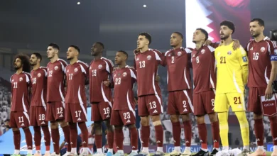 Qatar national football team players standing together before a FIFA World Cup match