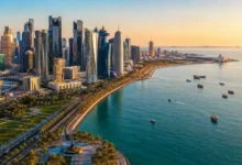 Doha Corniche waterfront and West Bay skyline in Doha Qatar during sunset