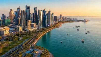 Doha Corniche waterfront and West Bay skyline in Doha Qatar during sunset