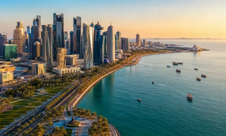Doha Corniche waterfront and West Bay skyline in Doha Qatar during sunset