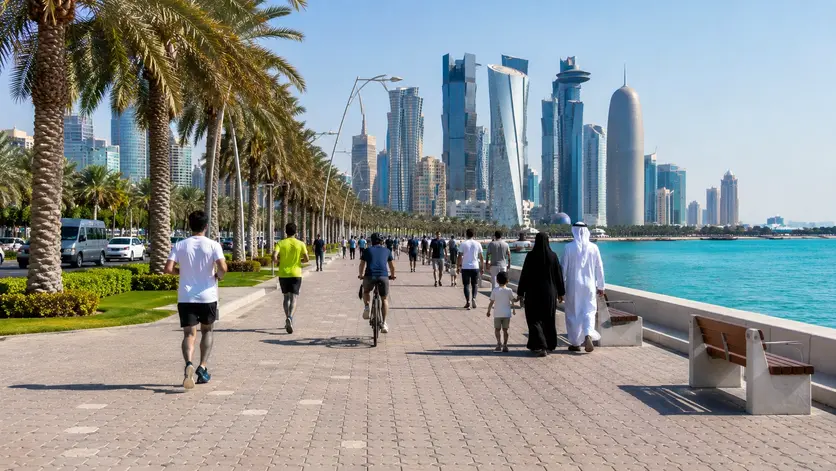 Visitors walking along the Doha Corniche promenade during the afternoon
